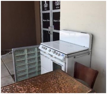 After: vintage stove cleaned and repaired for display on the patio by parking lot entrance